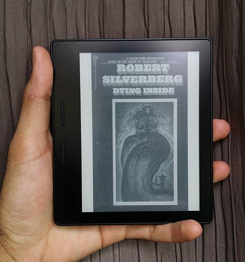 A picture of a Kindle with the book cover of 'Dying Inside' on display.