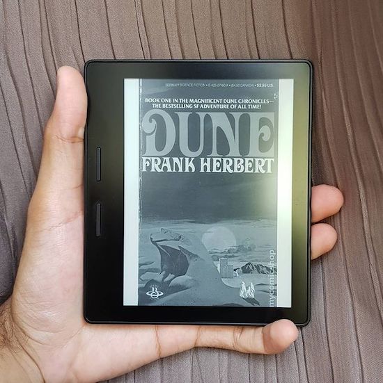 A picture of a Kindle with the book cover of 'Dune' on display.