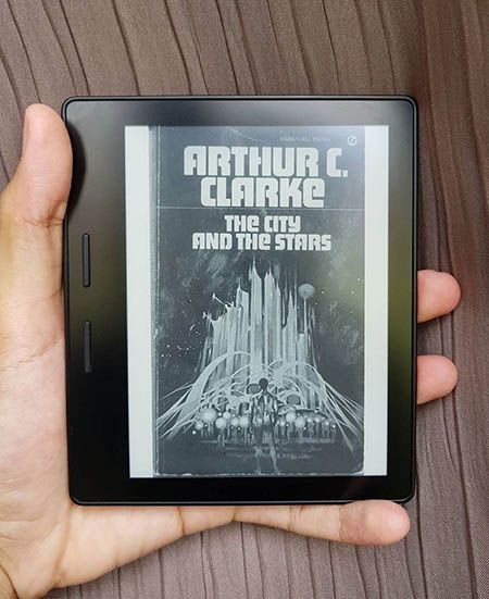 A picture of a Kindle with the book cover of 'The City and the Stars' on display.