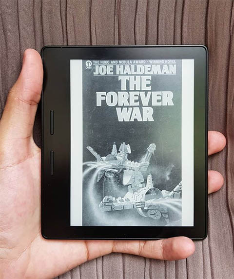 A picture of a Kindle with the cover of The Forever War book on display.