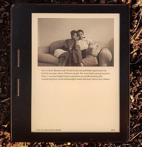 A picture of a photograph insert of Michelle and Barack Obama sitting on a couch as young lawyers, from her book