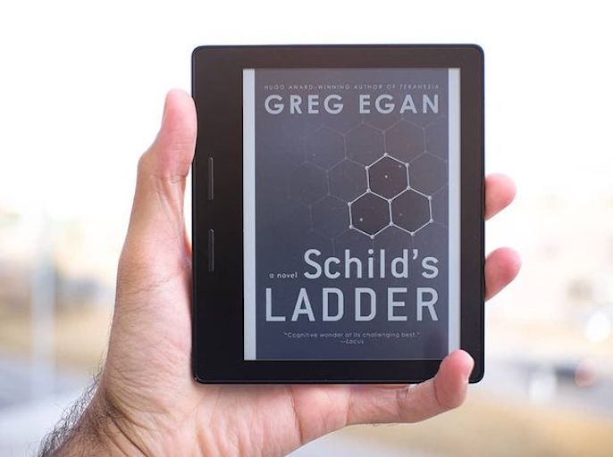 A picture of a Kindle with the book cover of 'Schild's Ladder' on display.